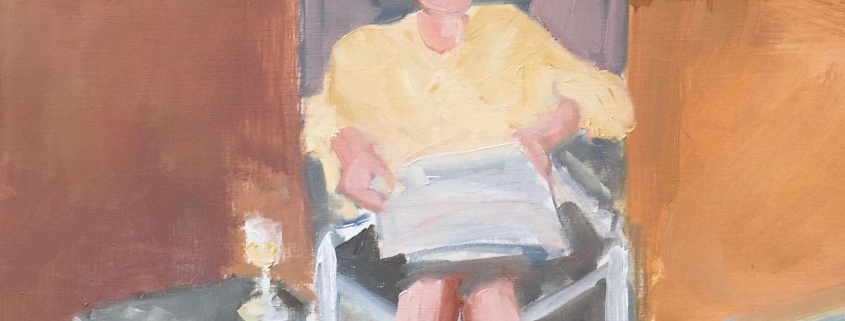 aan zee, met de krant aan het strand